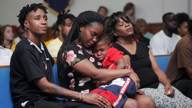 Brittany Jacobs consoles her 5-year-old son, Markeis McGlockton Jr., during a vigil for her slain boyfriend Markeis McGlockton Sr.